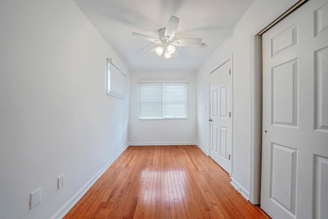 unfurnished bedroom with ceiling fan and light wood-type flooring