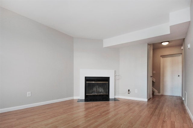 unfurnished living room with hardwood / wood-style flooring