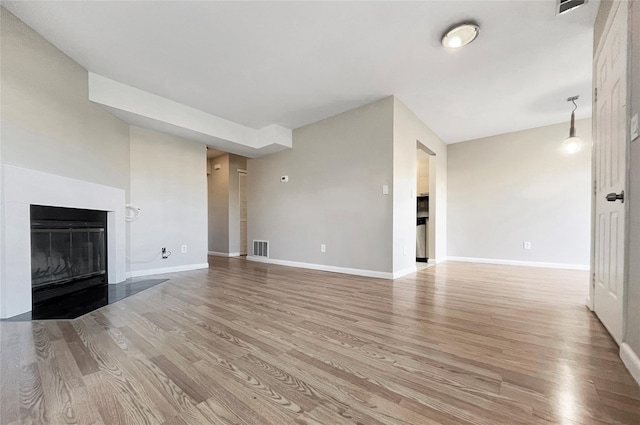 unfurnished living room featuring light wood-type flooring