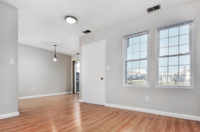 empty room with light hardwood / wood-style flooring