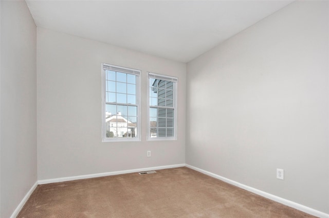 unfurnished room with light colored carpet