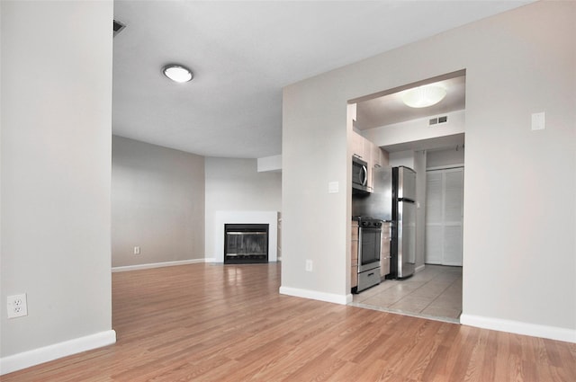 unfurnished living room with light hardwood / wood-style flooring