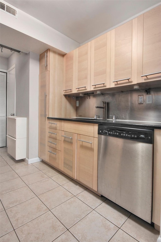 kitchen featuring light brown cabinets, sink, stainless steel dishwasher, backsplash, and light tile patterned floors