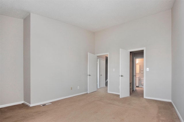 unfurnished bedroom featuring light colored carpet