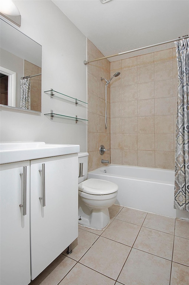 full bathroom featuring toilet, vanity, tile patterned floors, and shower / tub combo with curtain