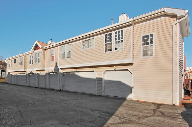 rear view of property featuring a garage