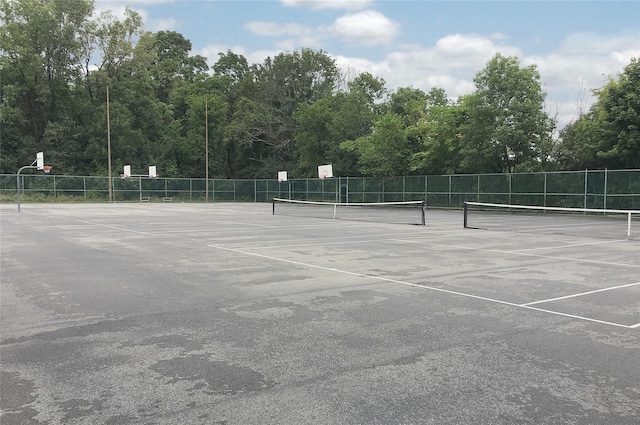 view of tennis court with basketball hoop