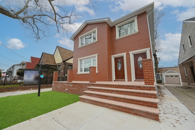 view of front facade featuring an outbuilding and a front lawn