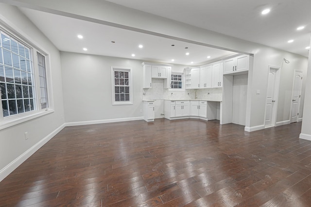 unfurnished living room featuring dark hardwood / wood-style flooring