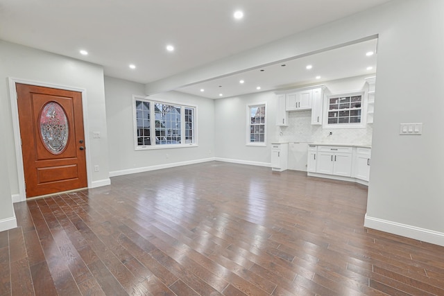 foyer entrance featuring dark wood-type flooring