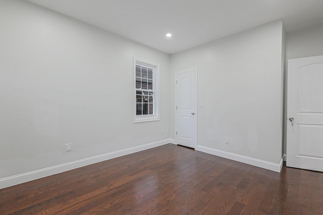 unfurnished room featuring dark hardwood / wood-style floors