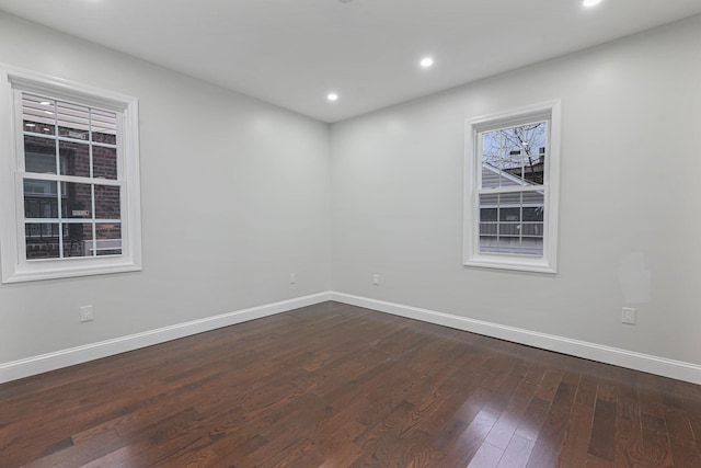 empty room with dark hardwood / wood-style floors