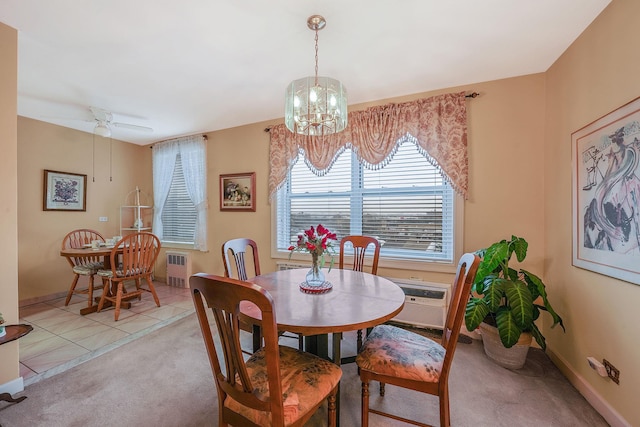 tiled dining room with radiator, a wall mounted air conditioner, and ceiling fan with notable chandelier