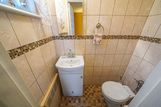 bathroom featuring vanity, toilet, and tile walls