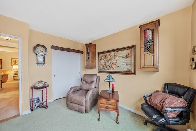 sitting room featuring light colored carpet