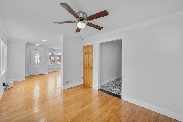 unfurnished room featuring crown molding, ceiling fan, and light hardwood / wood-style floors