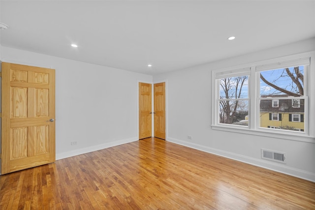 unfurnished room with light wood-type flooring