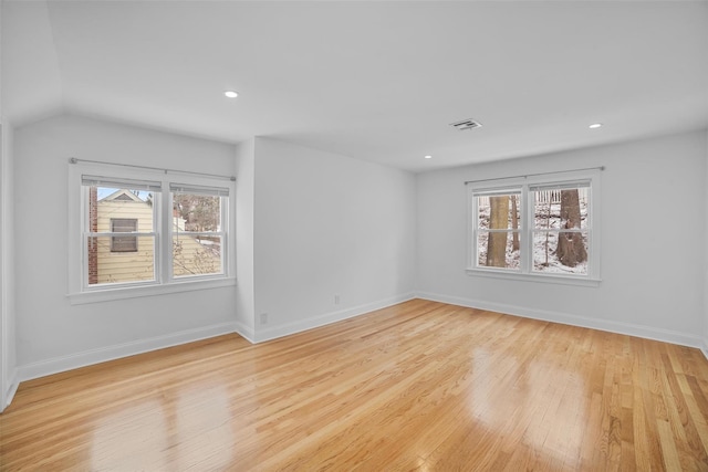 empty room featuring plenty of natural light and light wood-type flooring