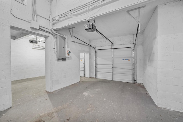 garage featuring electric panel and a garage door opener