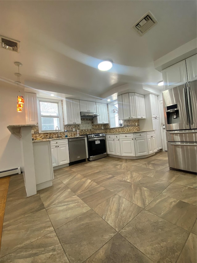 kitchen with decorative backsplash, appliances with stainless steel finishes, sink, white cabinets, and hanging light fixtures