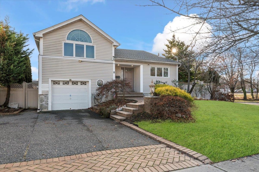 front facade featuring a garage and a front yard