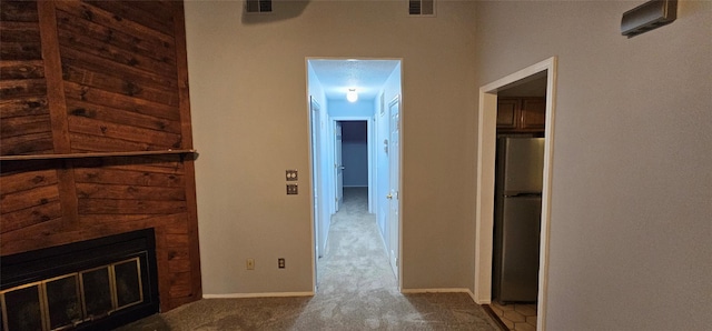 hall featuring wood walls and light colored carpet