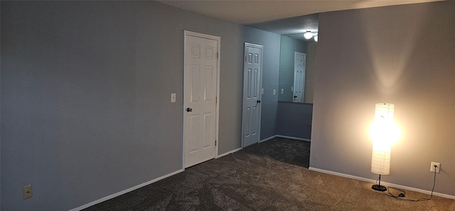 corridor with dark colored carpet