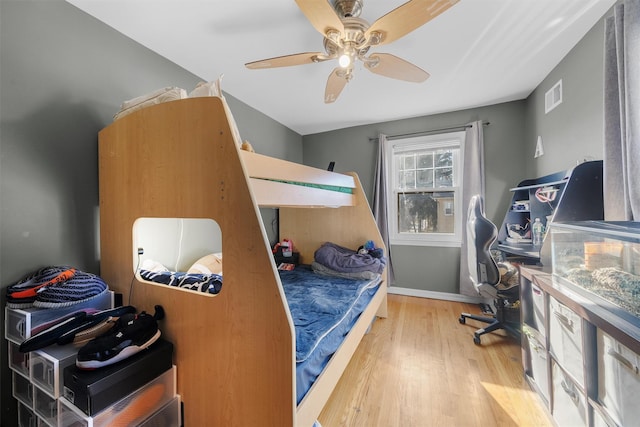 bedroom with ceiling fan and wood-type flooring