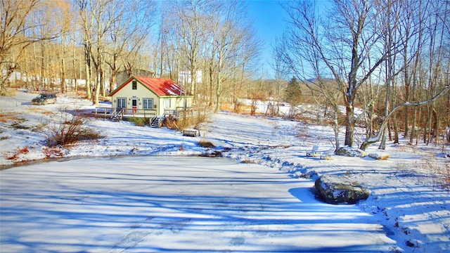 yard covered in snow featuring a wooden deck