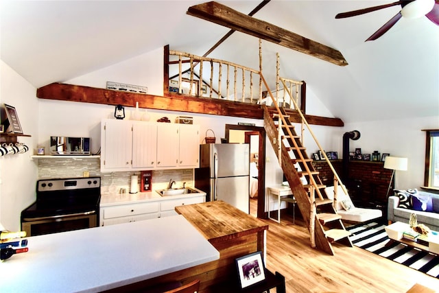 kitchen featuring stainless steel appliances, ceiling fan, sink, light hardwood / wood-style flooring, and white cabinetry