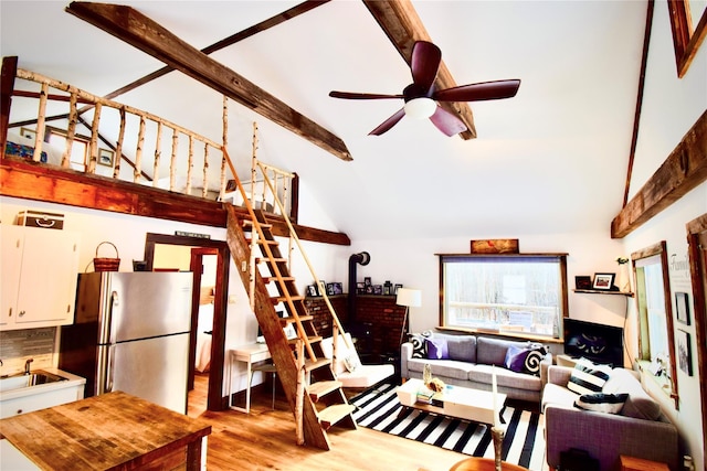 living room with high vaulted ceiling, sink, ceiling fan, beamed ceiling, and light hardwood / wood-style floors