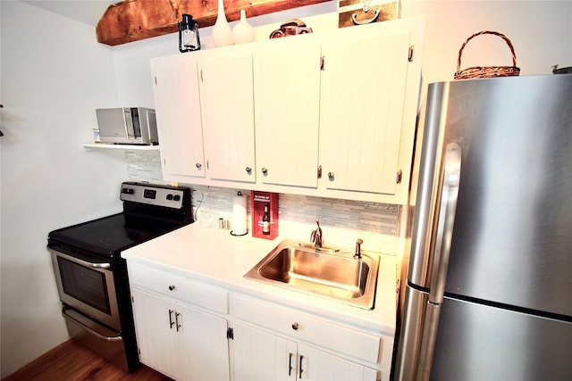 kitchen with sink, stainless steel appliances, dark hardwood / wood-style flooring, backsplash, and white cabinets