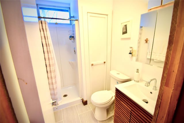 bathroom with tile patterned flooring, vanity, curtained shower, and toilet