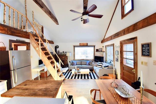 dining room with beam ceiling, ceiling fan, high vaulted ceiling, and wood-type flooring