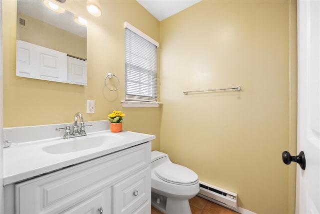 bathroom featuring vanity, toilet, a baseboard heating unit, and tile patterned flooring