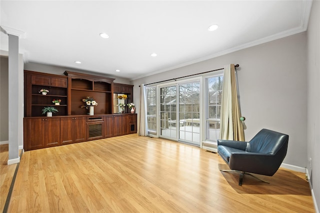 sitting room featuring light hardwood / wood-style floors and ornamental molding