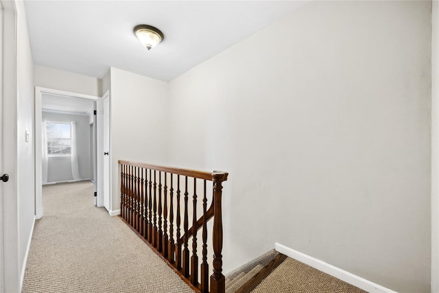 corridor featuring light colored carpet