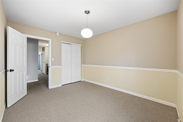 unfurnished bedroom featuring a closet and carpet flooring