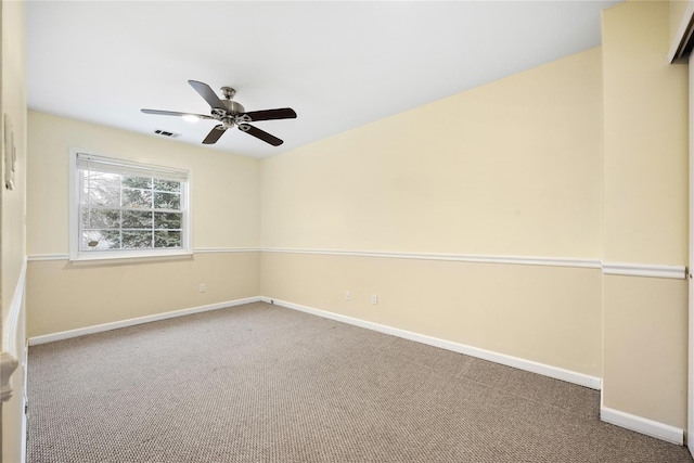 spare room featuring ceiling fan and carpet