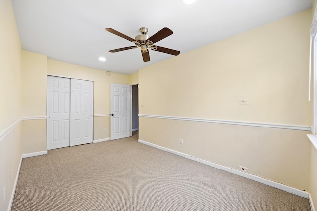 unfurnished bedroom featuring ceiling fan, a closet, and light carpet