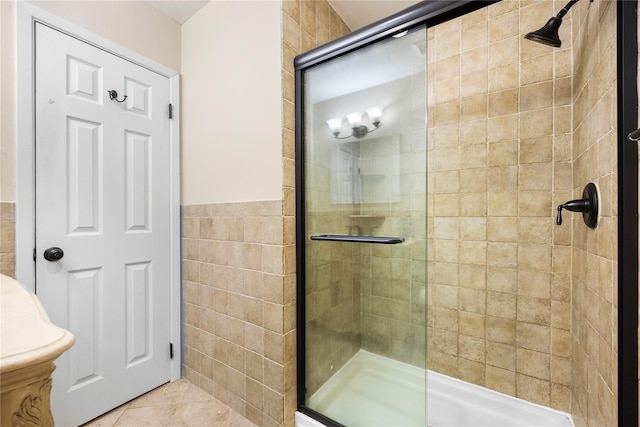 bathroom featuring an enclosed shower and tile walls