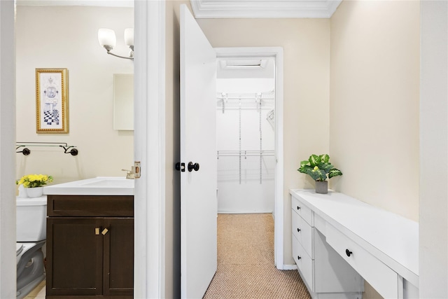 bathroom featuring crown molding, toilet, and vanity