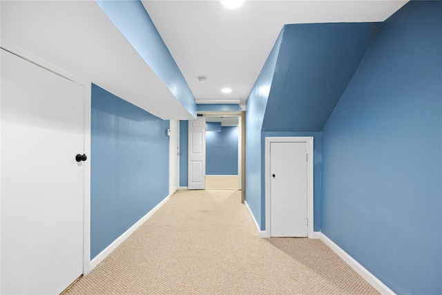 hallway featuring light colored carpet