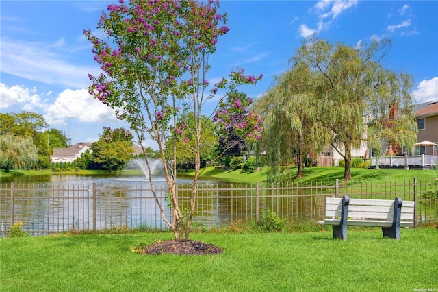 exterior space with a water view and a yard