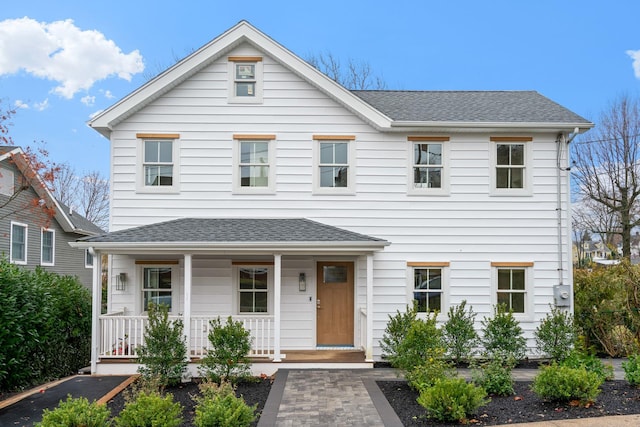 view of front of property featuring a porch and roof with shingles