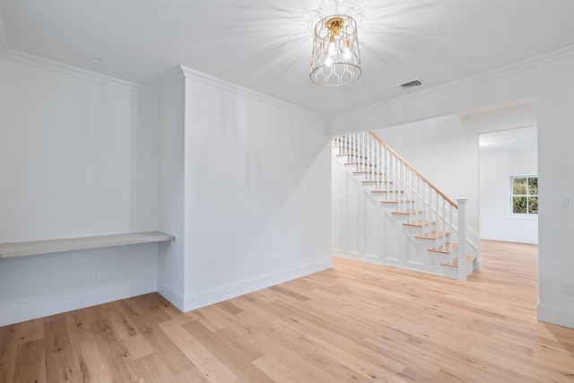 interior space featuring ornamental molding, visible vents, and wood finished floors