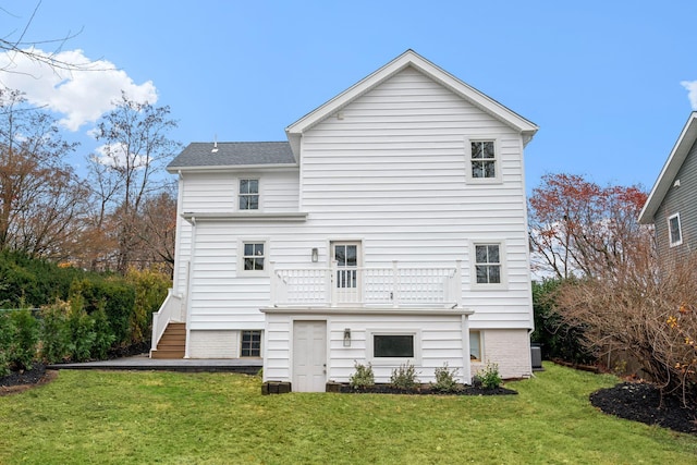 rear view of house featuring a lawn