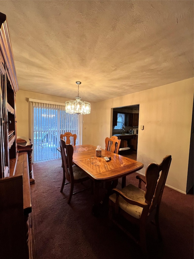 dining area with carpet, a textured ceiling, and a notable chandelier