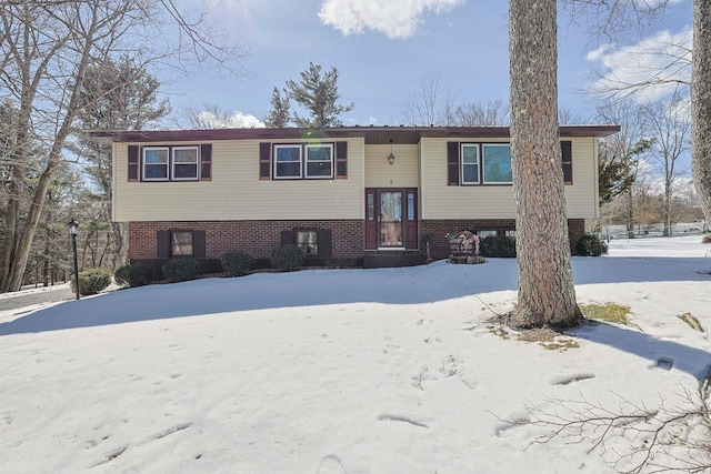 split foyer home featuring brick siding