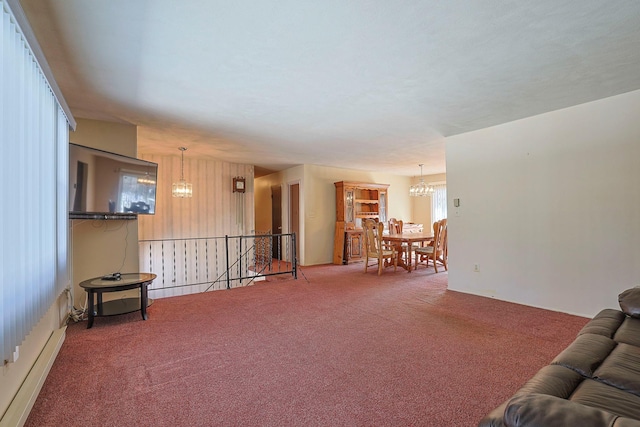 living room featuring carpet floors, an inviting chandelier, and baseboard heating